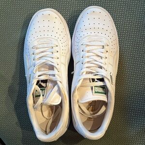 Puma GV Special sneakers in white with gold writing in US size 4C.